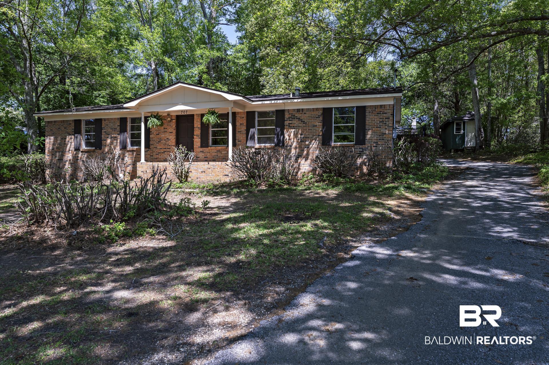 707 Johnson Avenue Fairhope, AL 36532 - Photo 1 of 38 Single story home with aphalt driveway and brick siding