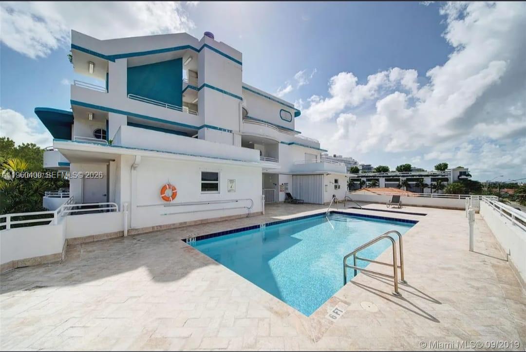 9156 Collins Avenue, Unit 502 Surfside, FL 33154 - Photo 14 of 20 a swimming pool with outdoor seating and yard