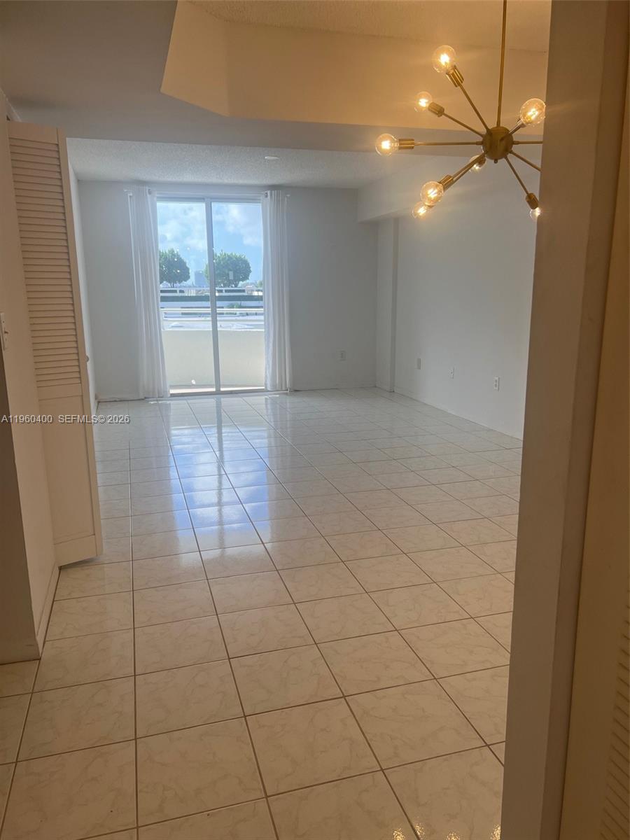 9156 Collins Avenue, Unit 502 Surfside, FL 33154 - Photo 2 of 20 a view of an empty room and a chandelier fan