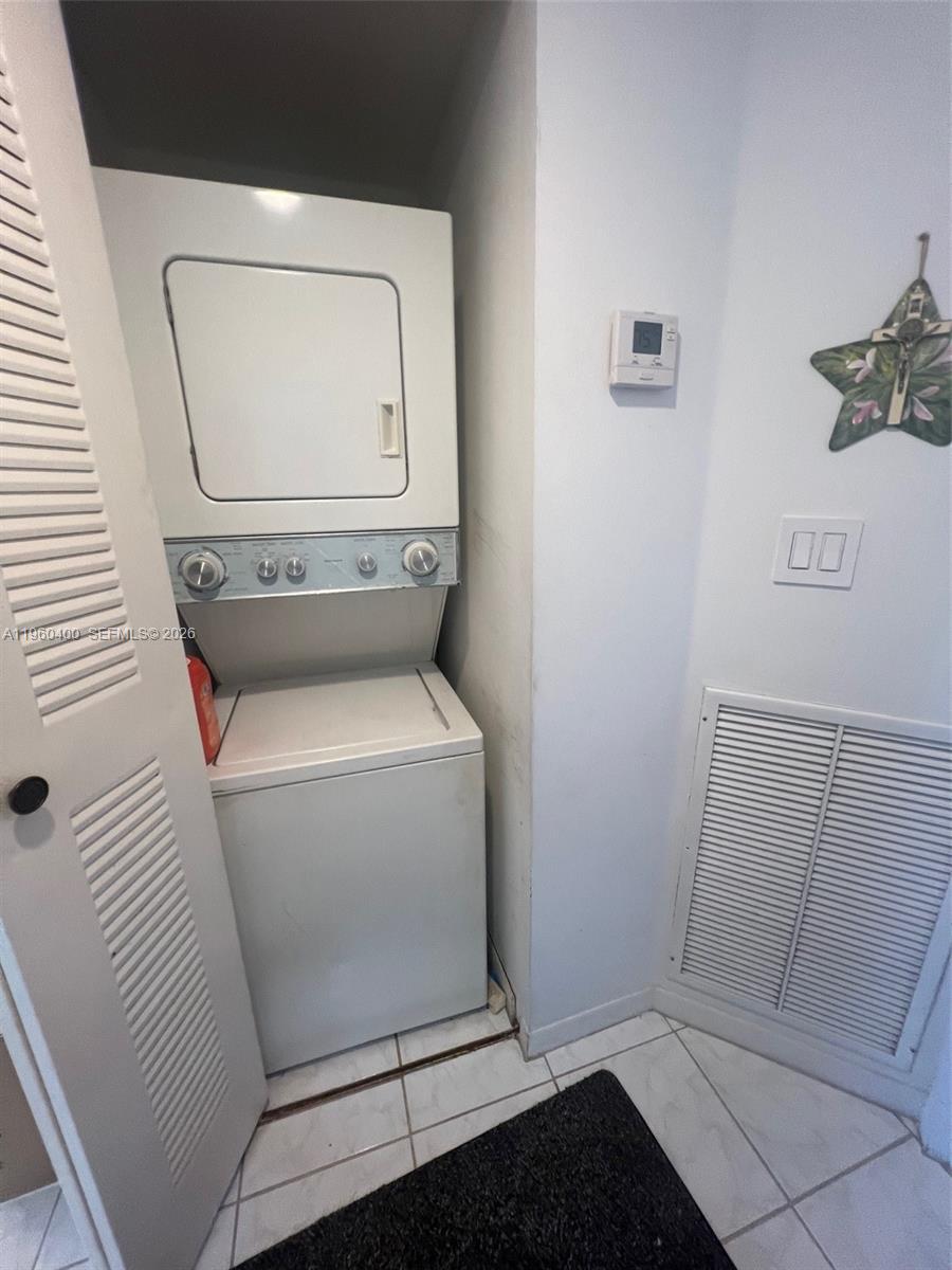 9156 Collins Avenue, Unit 502 Surfside, FL 33154 - Photo 8 of 20 a utility room with dryer and washer