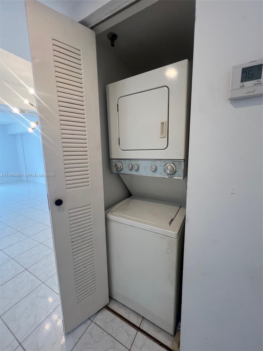 9156 Collins Avenue, Unit 502 Surfside, FL 33154 - Photo 9 of 20 a utility room with dryer and washer