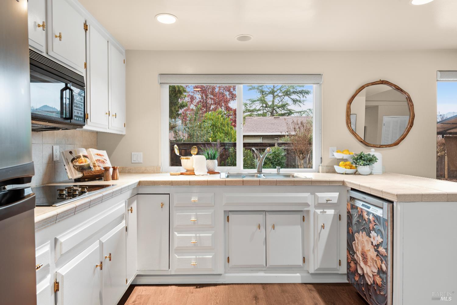 8853 Oak Trail Court Santa Rosa, CA 95409 - Photo 15 of 39 Large windows across the back wall provide views of the backyard and give the workspace morning light