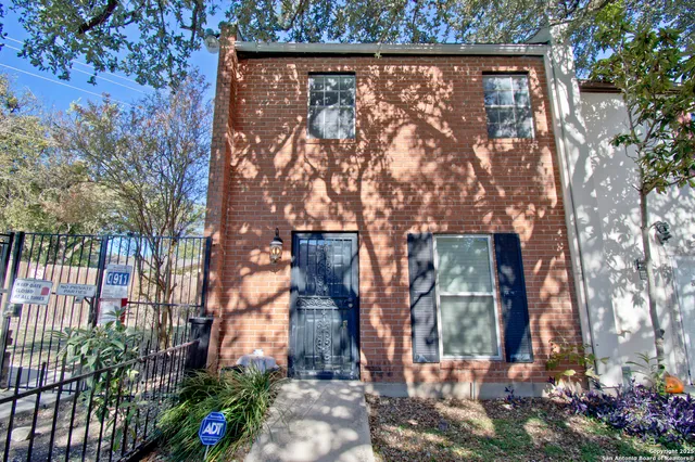front view of a house with a tree