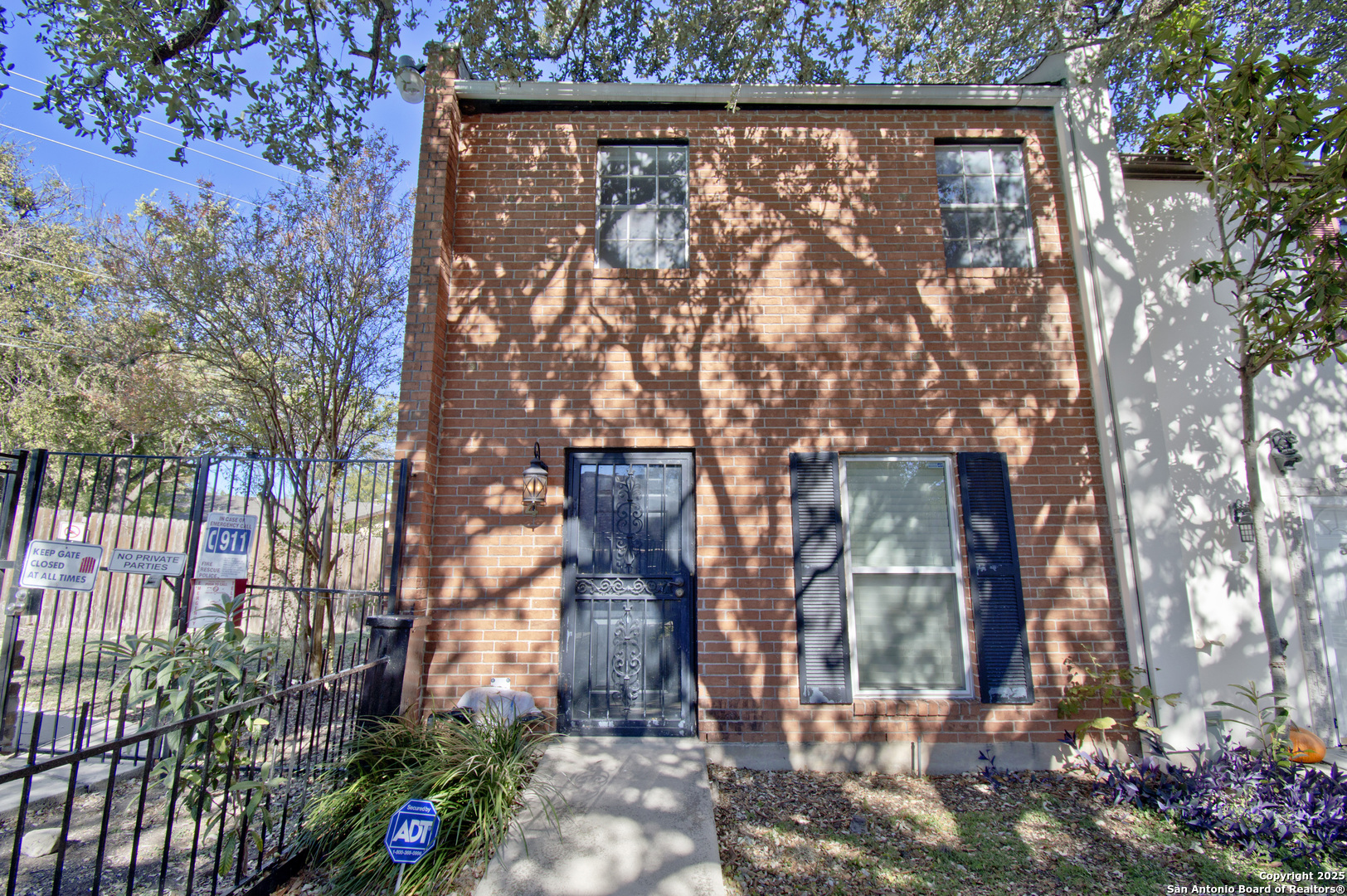front view of a house with a tree