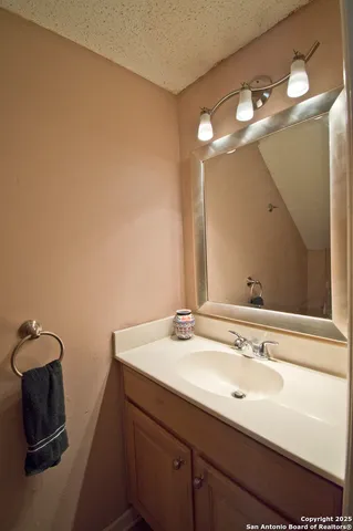 a bathroom with a sink and mirror