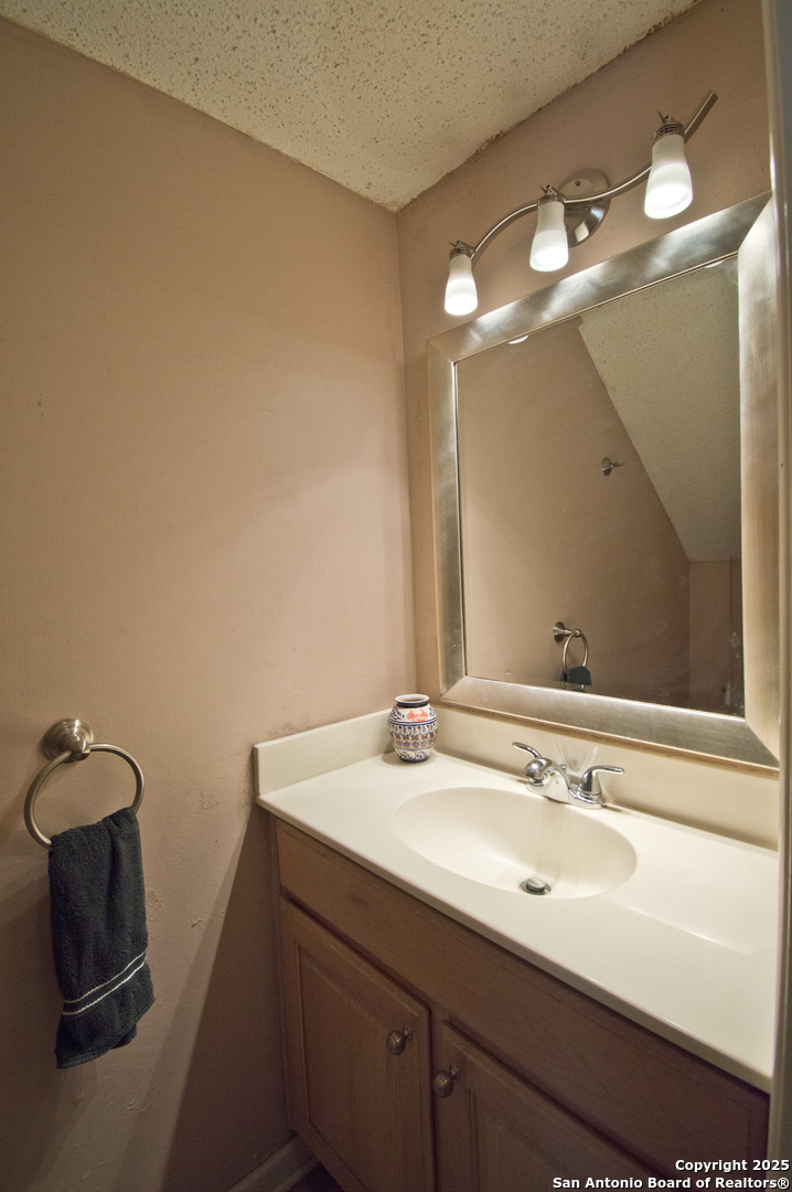 6427 Wurzbach Road, Unit 4 San Antonio, TX 78240 - Photo 12 of 30 a bathroom with a sink and a mirror