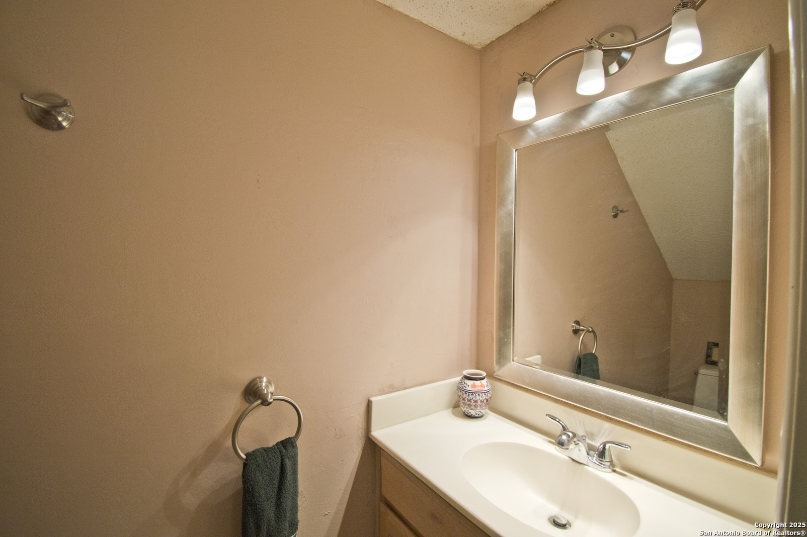 6427 Wurzbach Road, Unit 4 San Antonio, TX 78240 - Photo 13 of 30 a bathroom with a sink and mirror