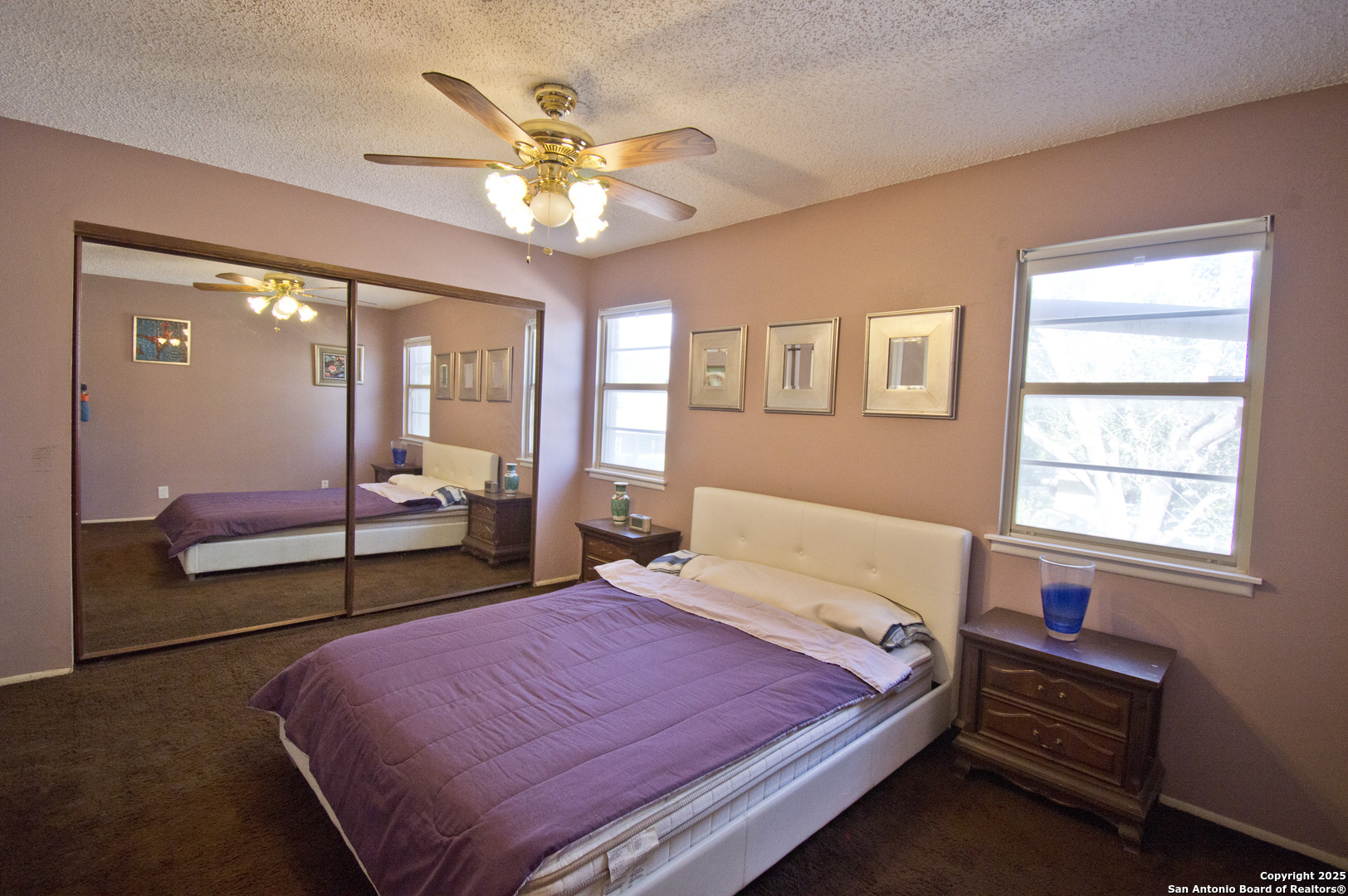 6427 Wurzbach Road, Unit 4 San Antonio, TX 78240 - Photo 16 of 30 a spacious bedroom with a bed and a chandelier