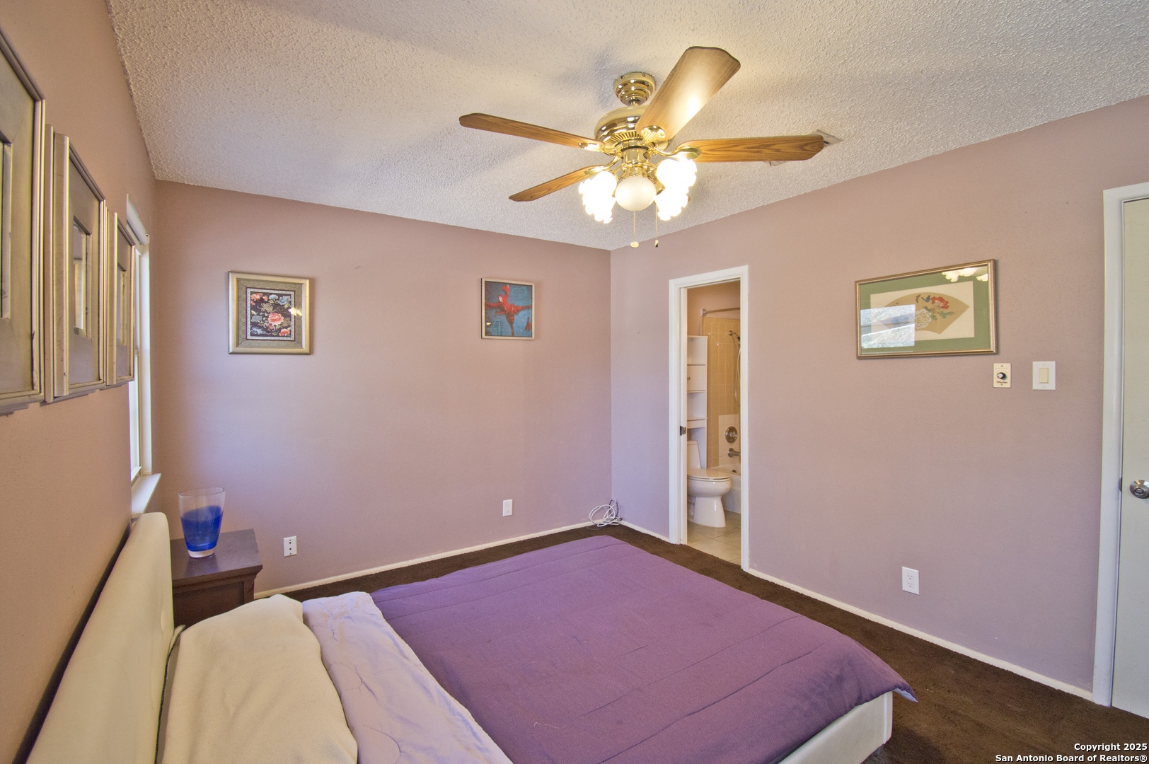 6427 Wurzbach Road, Unit 4 San Antonio, TX 78240 - Photo 17 of 30 a bedroom with a bed and a chandelier