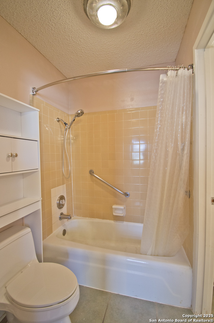6427 Wurzbach Road, Unit 4 San Antonio, TX 78240 - Photo 20 of 30 a bathroom with a toilet and shower