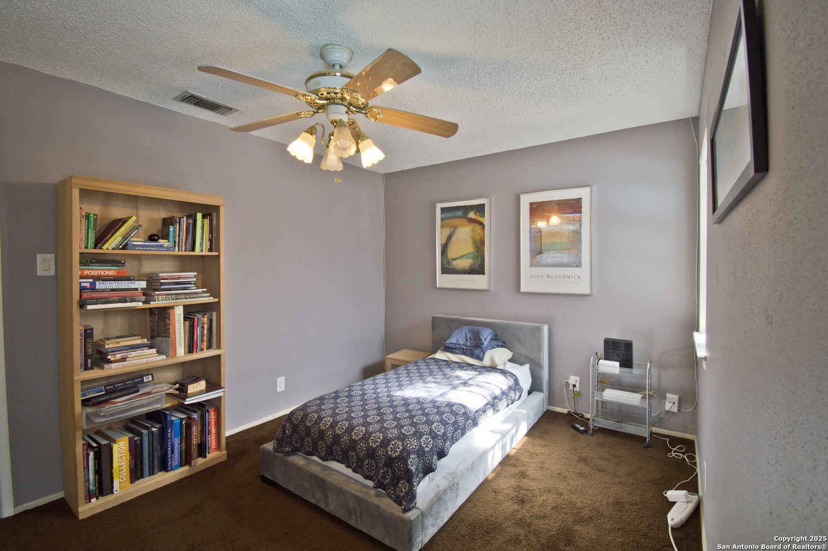 6427 Wurzbach Road, Unit 4 San Antonio, TX 78240 - Photo 21 of 30 a bedroom with furniture and a book shelf