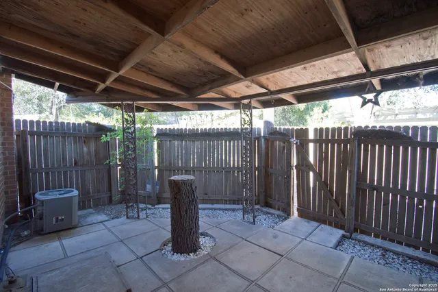 a view of a backyard with plants and a patio