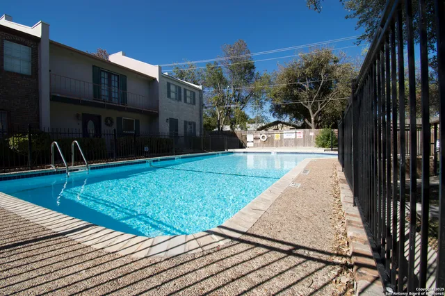 a view of a sign board with large tree