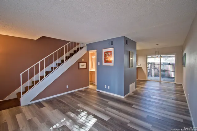 a view of entryway and hall with wooden floor