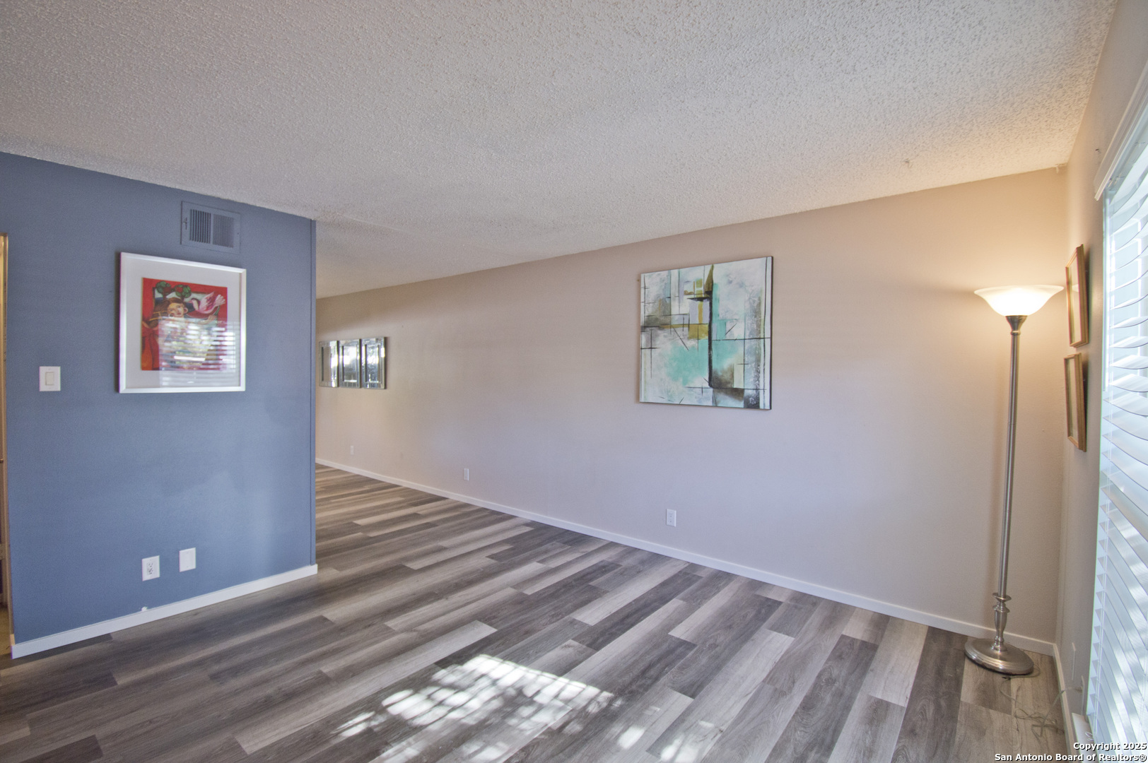 6427 Wurzbach Road, Unit 4 San Antonio, TX 78240 - Photo 6 of 30 a view of an empty room with wooden floor and a window