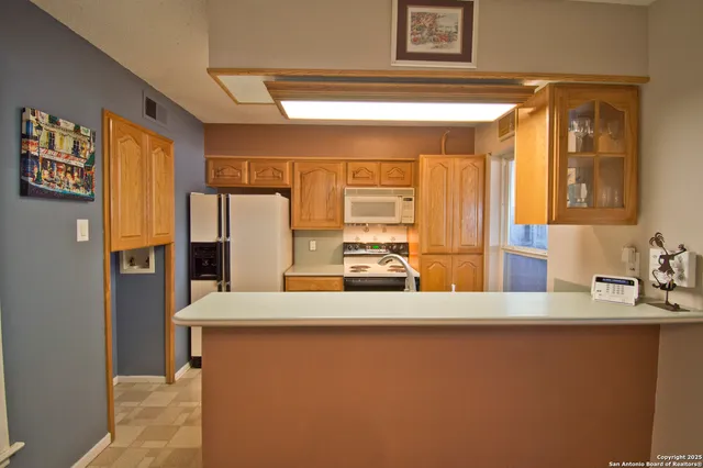 a kitchen with stainless steel appliances a stove a sink and a refrigerator
