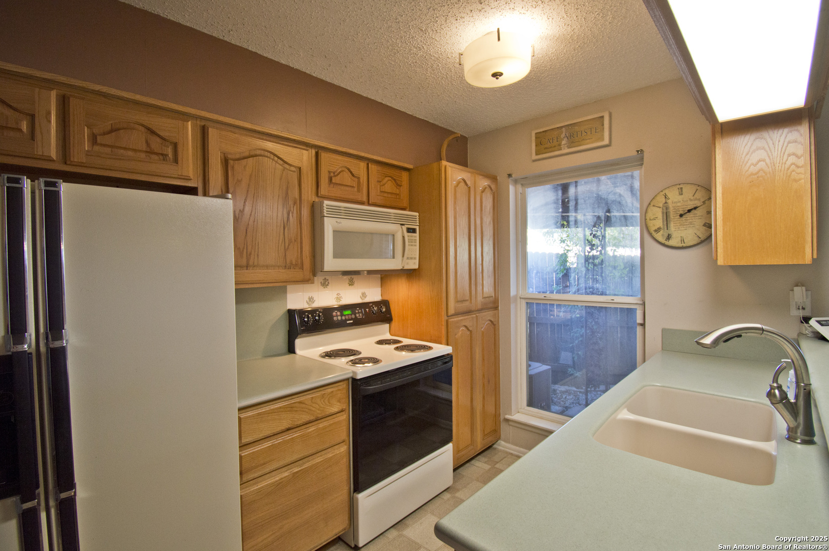 6427 Wurzbach Road, Unit 4 San Antonio, TX 78240 - Photo 10 of 30 a kitchen with stainless steel appliances a stove a sink and a refrigerator