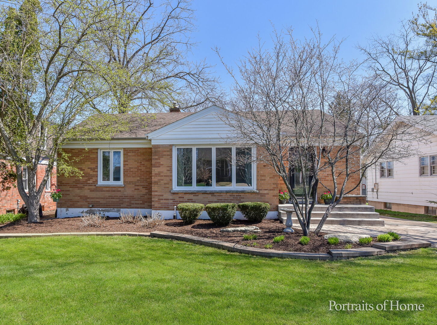 856 North Webster Street Naperville, IL 60563 - Photo 1 of 21 a front view of a house with a yard table and chairs