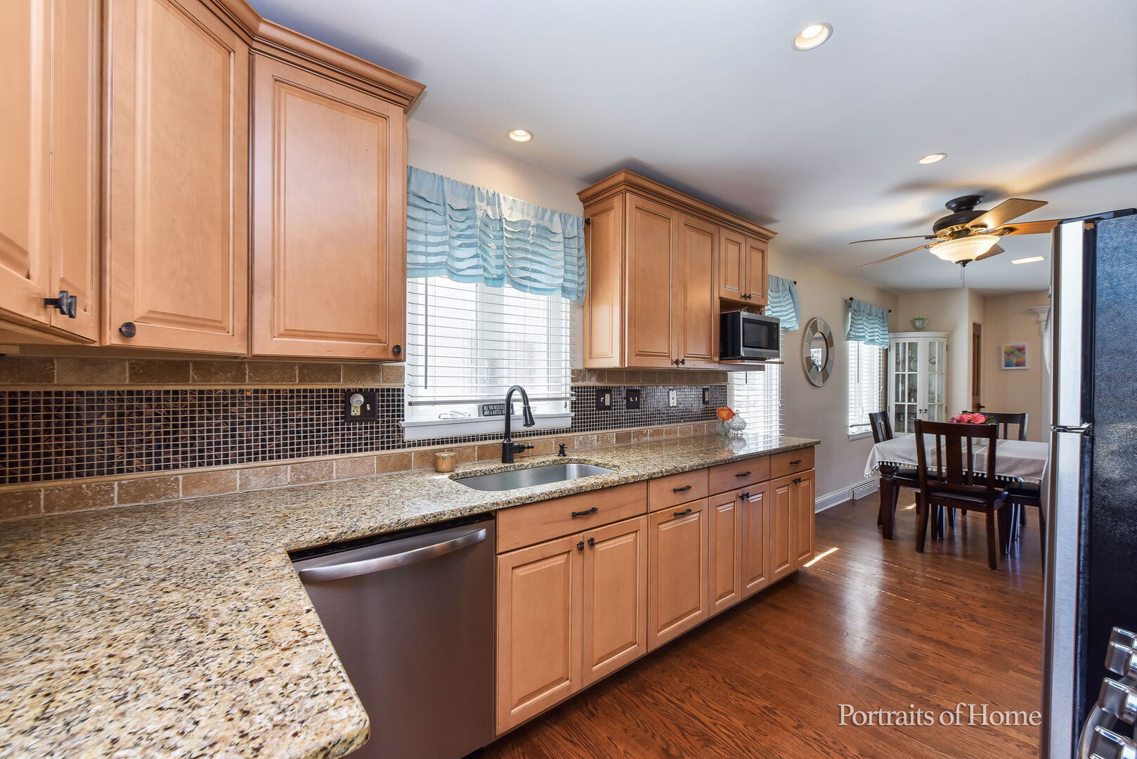 856 North Webster Street Naperville, IL 60563 - Photo 6 of 21 a kitchen with stainless steel appliances granite countertop a sink dishwasher stove and cabinets with wooden floor