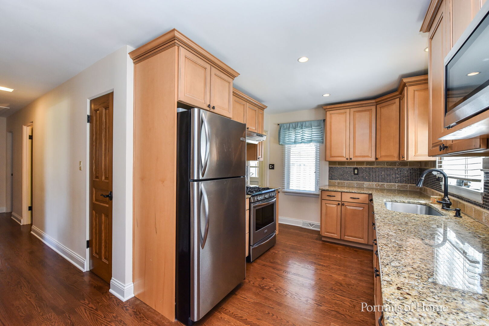 856 North Webster Street Naperville, IL 60563 - Photo 7 of 21 a kitchen with granite countertop a refrigerator and a stove top oven