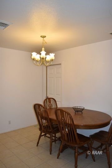 1117 South McCall Street Ridgecrest, CA 93555 - Photo 3 of 11 a view of a dining room with furniture and chandelier