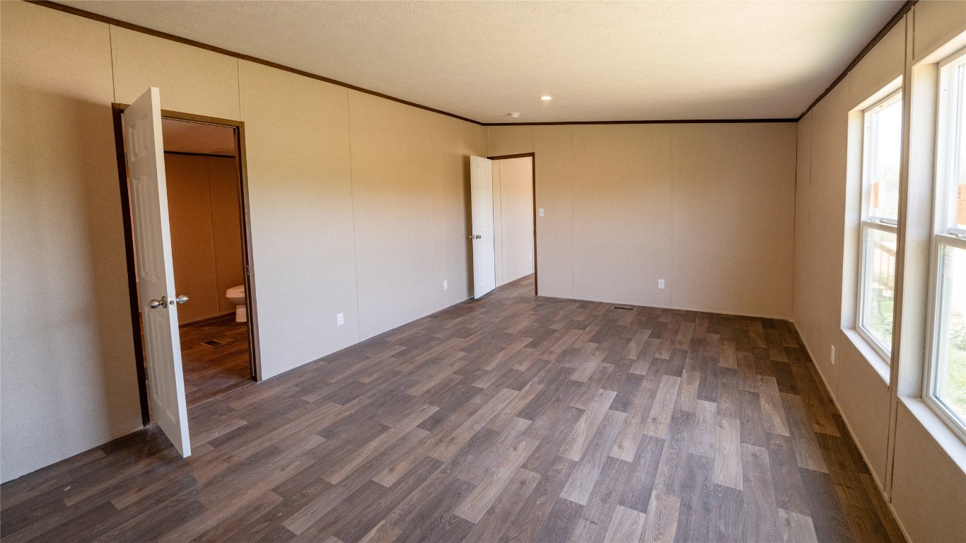 1121 Callihan Road Luling, TX 78648 - Photo 12 of 35 a view of empty room with wooden floor and fan