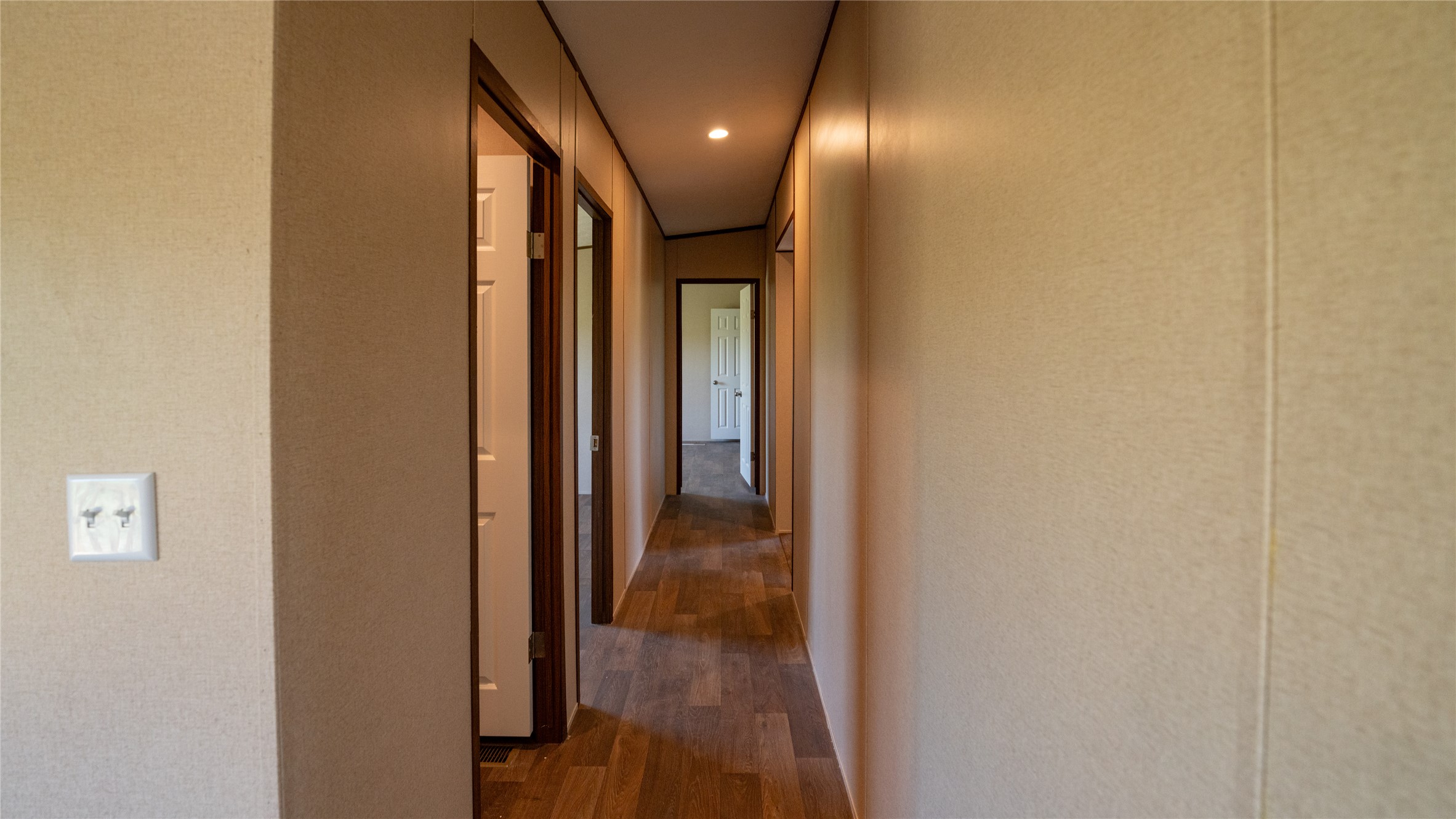1121 Callihan Road Luling, TX 78648 - Photo 23 of 35 Hallway with wood finished floors and recessed lighting
