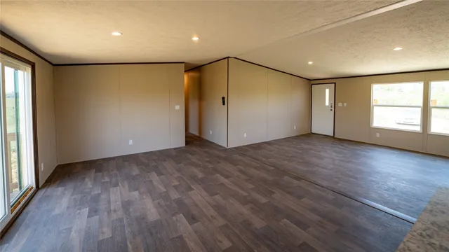 a kitchen with granite countertop a stove a sink and dishwasher with wooden floor