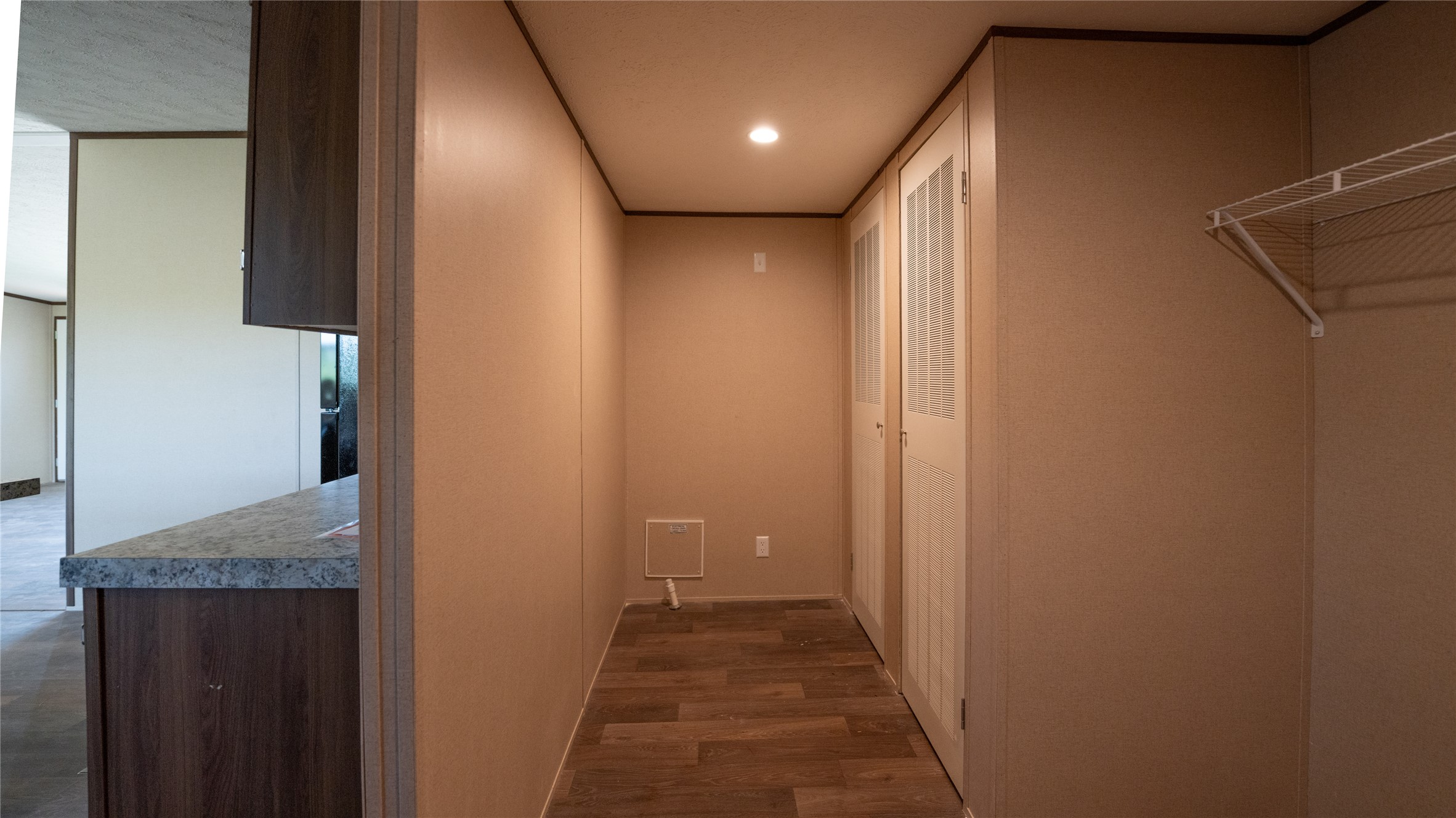 1121 Callihan Road Luling, TX 78648 - Photo 26 of 35 Corridor with dark wood-style flooring and recessed lighting