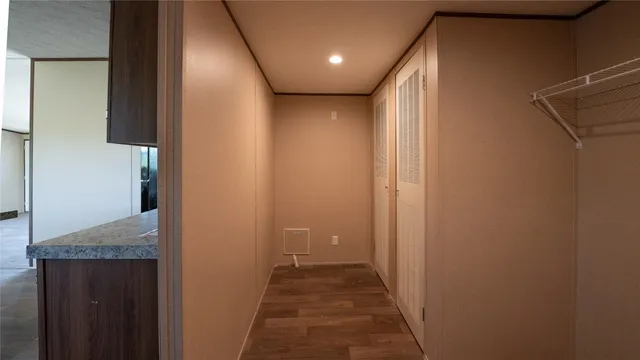 a kitchen with granite countertop a sink cabinets and stainless steel appliances