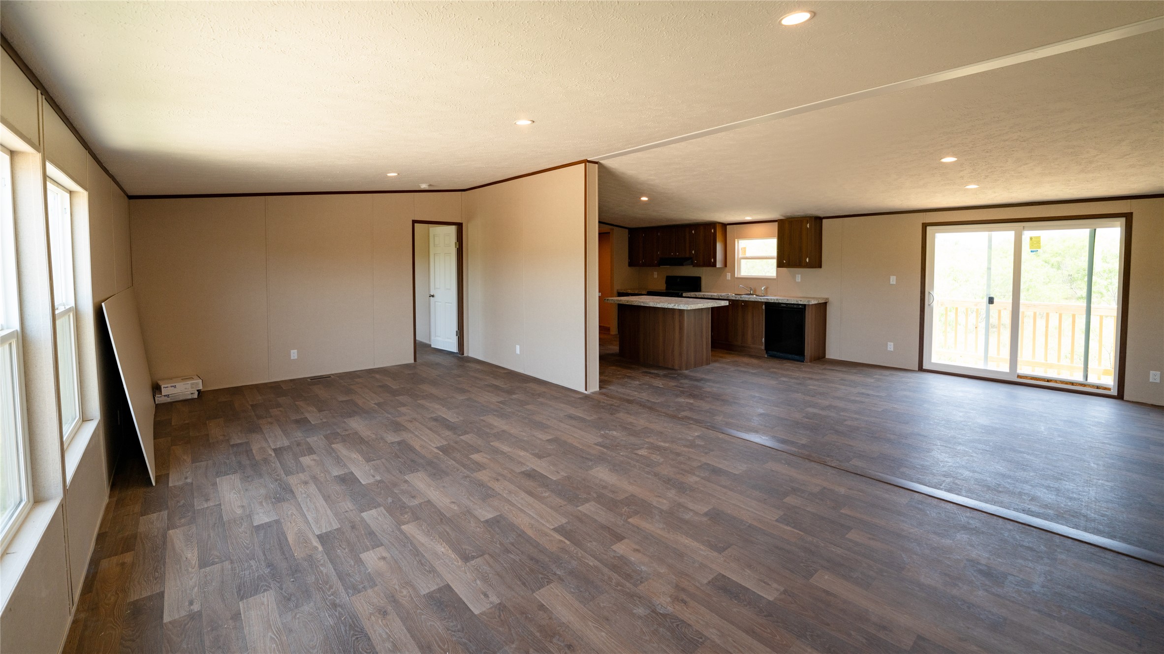 1121 Callihan Road Luling, TX 78648 - Photo 29 of 35 Unfurnished living room featuring dark wood-style flooring and recessed lighting