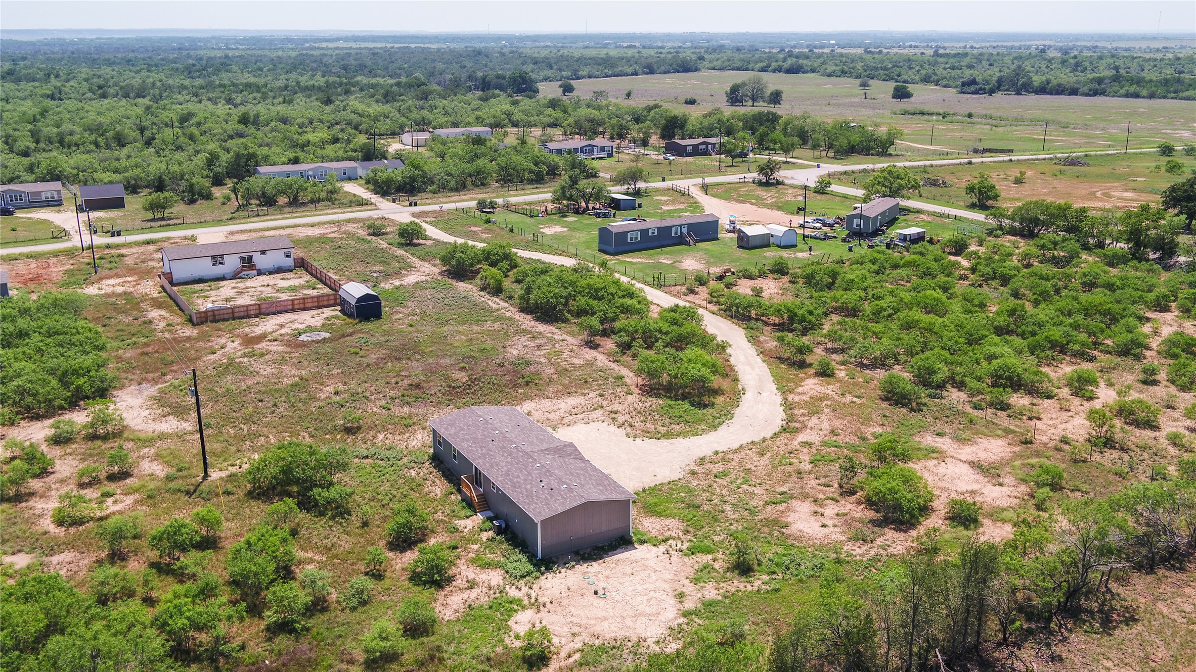1121 Callihan Road Luling, TX 78648 - Photo 31 of 35 Aerial view of sparsely populated area with a heavily wooded area
