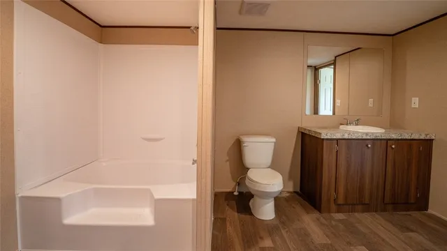 a bathroom with a toilet and a shower