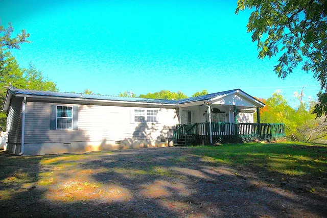 a view of house with backyard