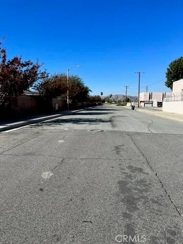 a view of a rural road with plants