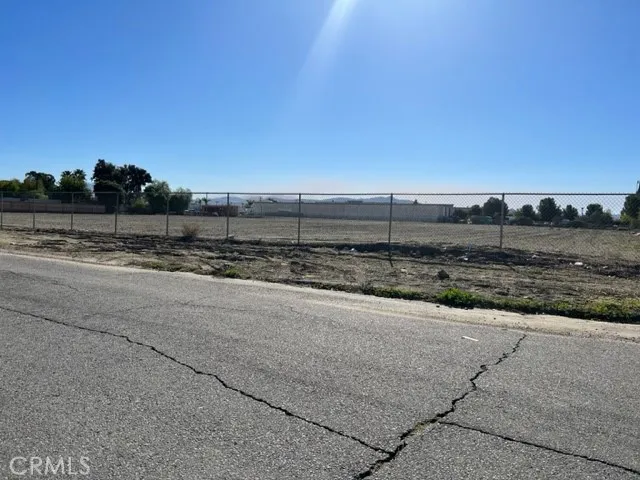 a view of a dry space with lots of trees