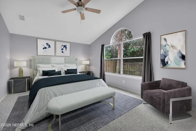 an empty room with windows and view of a livingroom