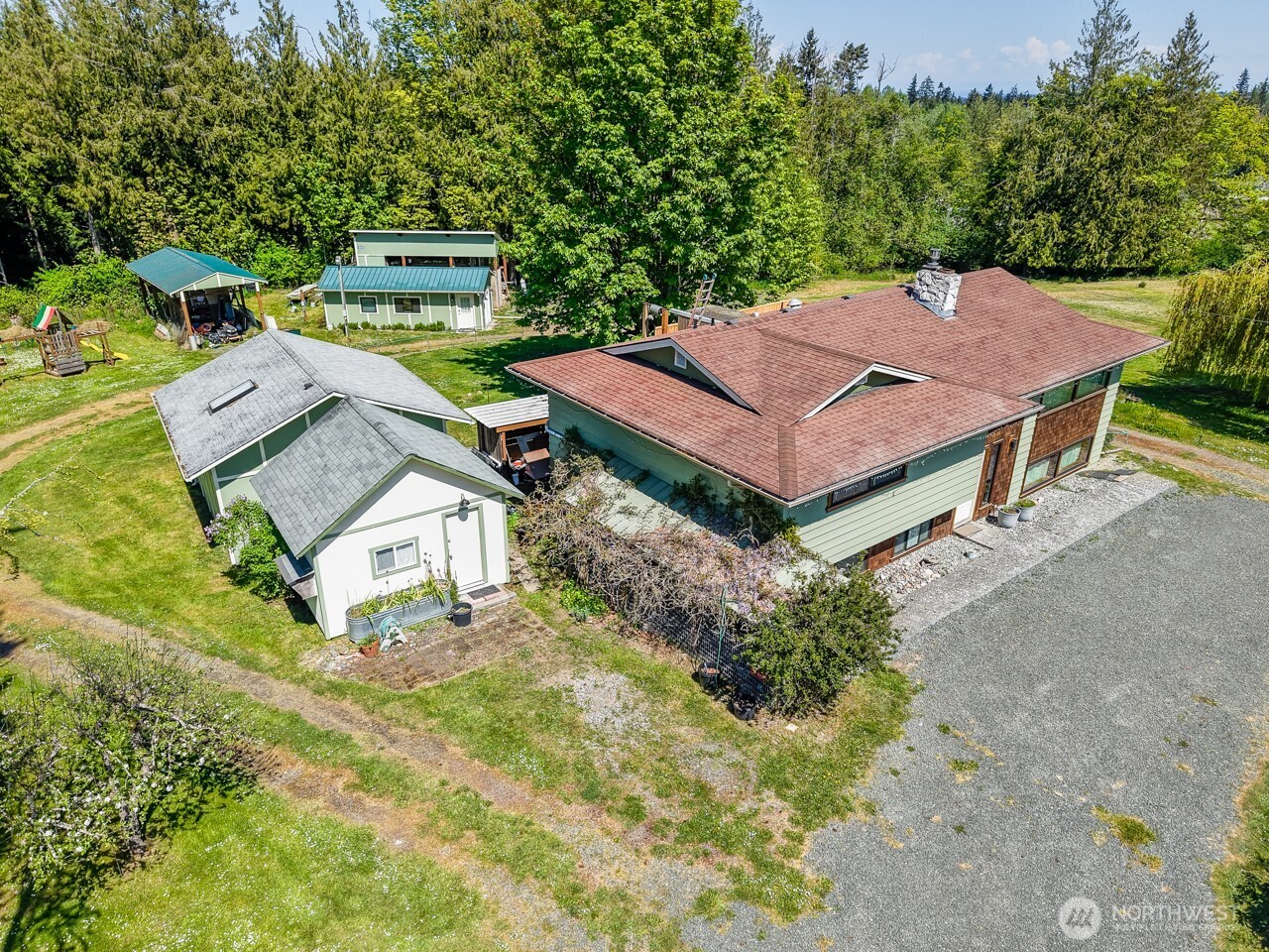 63 East Arnette Road Port Angeles, WA 98362 - Photo 3 of 40 an aerial view of a house with swimming pool and big yard