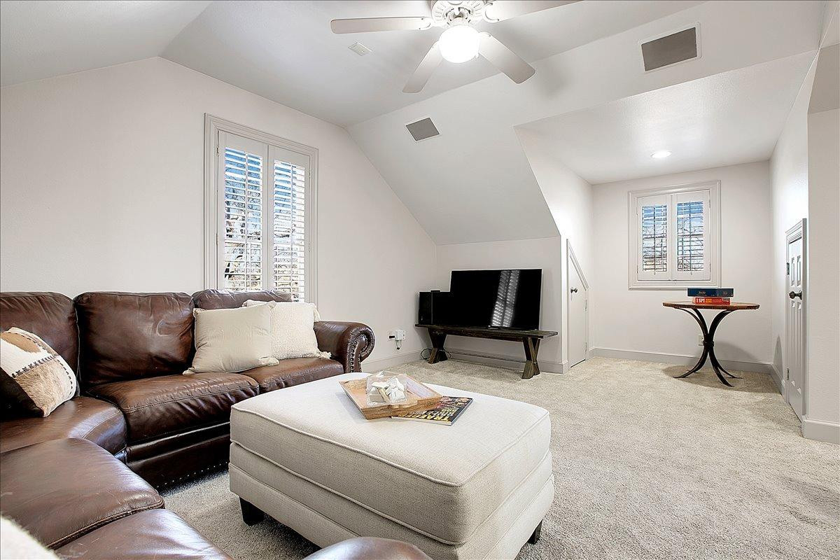 3203 32nd Street Lubbock, TX 79410 - Photo 17 of 27 a living room with furniture a flat screen tv and a window