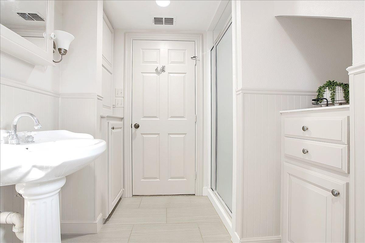 3203 32nd Street Lubbock, TX 79410 - Photo 18 of 27 a bathroom with a sink and mirror