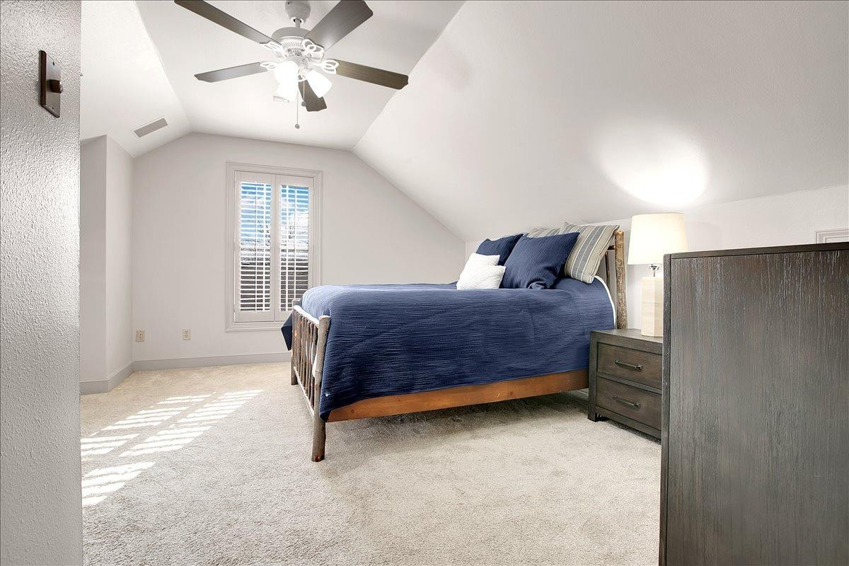 3203 32nd Street Lubbock, TX 79410 - Photo 20 of 27 a bedroom with a bed and a ceiling fan