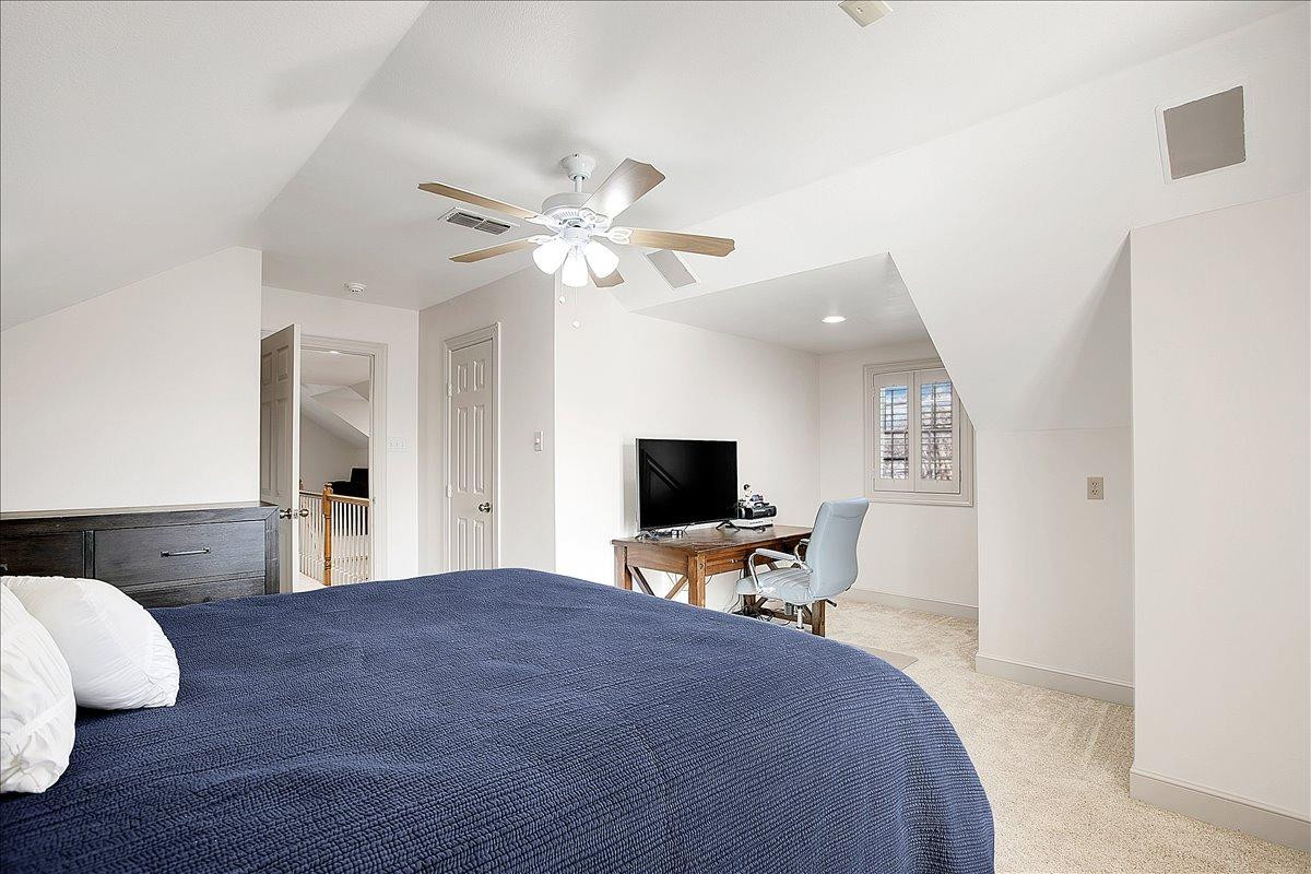 3203 32nd Street Lubbock, TX 79410 - Photo 21 of 27 a spacious bedroom with a bed and a flat screen tv