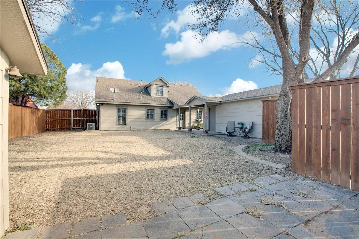 3203 32nd Street Lubbock, TX 79410 - Photo 23 of 27 a front view of a house with a yard and garage
