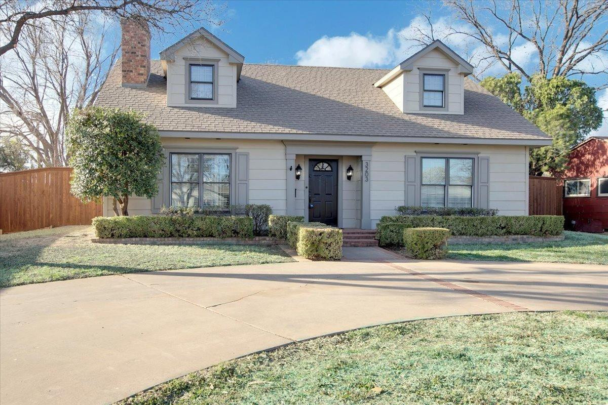 3203 32nd Street Lubbock, TX 79410 - Photo 3 of 27 a front view of a house with a yard and a garage
