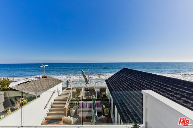 a view of roof deck with ocean view