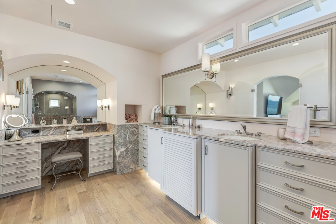 23626 Malibu Colony Road, Unit 53 Malibu, CA 90265 - Photo 18 of 24 a spacious bathroom with a granite countertop sink mirror and a