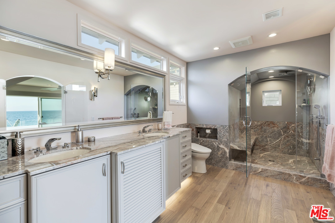 23626 Malibu Colony Road, Unit 53 Malibu, CA 90265 - Photo 19 of 24 a bathroom with a double vanity sink mirror and shower