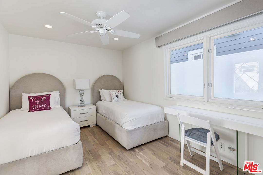 23626 Malibu Colony Road, Unit 53 Malibu, CA 90265 - Photo 22 of 24 a bedroom with a bed and a chandelier