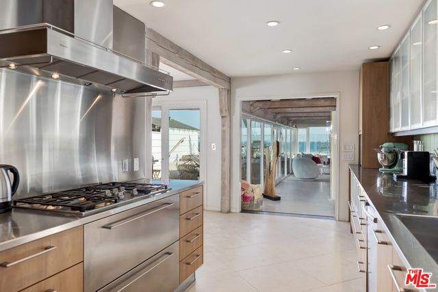 a kitchen with stainless steel appliances granite countertop a stove a sink and a refrigerator