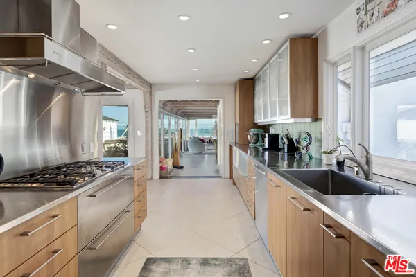 a kitchen with counter top space and stainless steel appliances